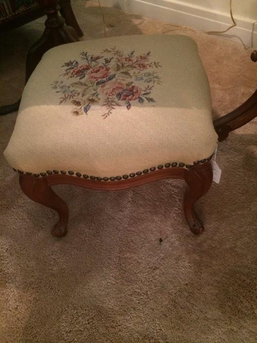 One of several needlepoint foot stools