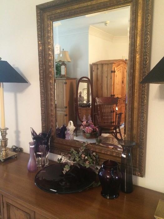 Triple dresser; decorative glassware in purple; matching lamps with black shades;  framed mirror; antique rocker; 2 pine armoires; oval floor mirror