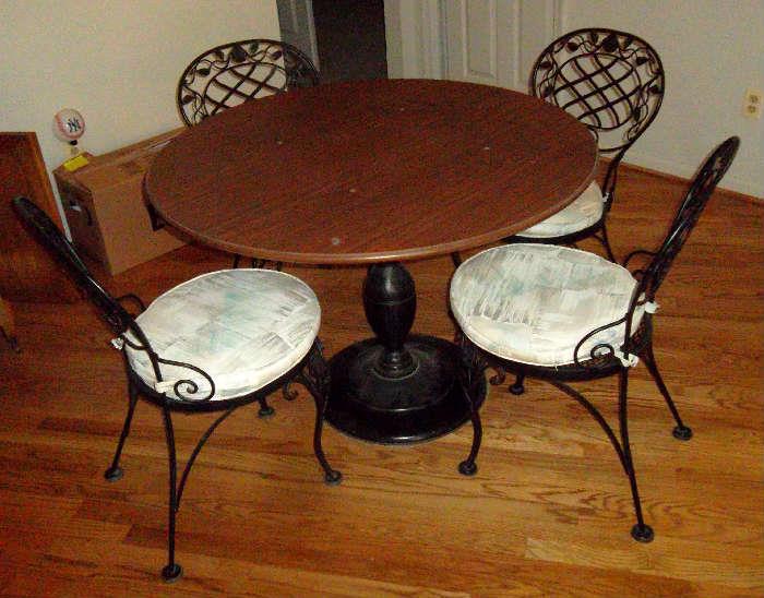 Metal base, wood top. Chair pads can be removed