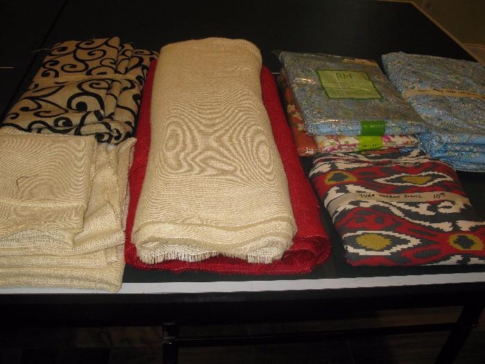 Burlap fabric and table cloths to the right