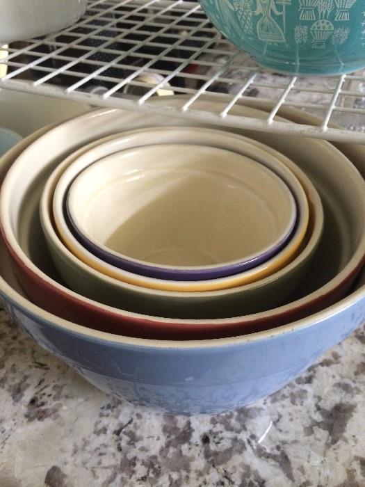 Five colorful mixing bowls