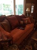 Comfy cinnamon colored sofa with decorative pillows