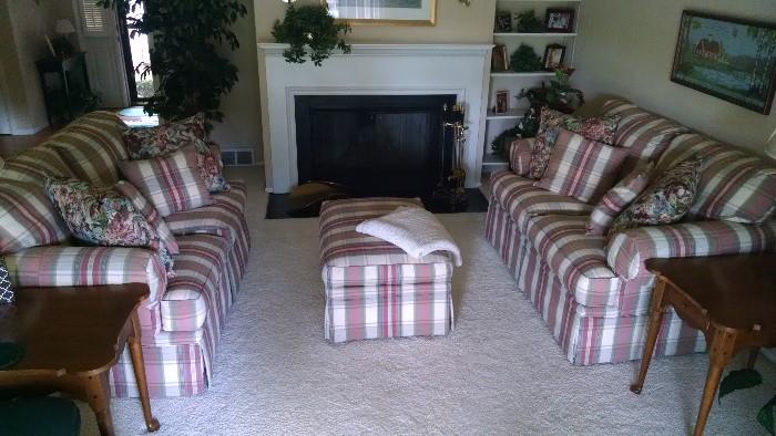 Double Pastel Plaid loveseats and matching ottoman accent the creamy neutral decor