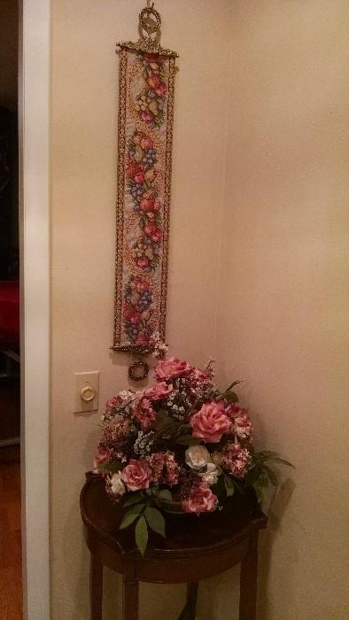 Embroidered bell pull with brass hardware, silk flowers, occasional table