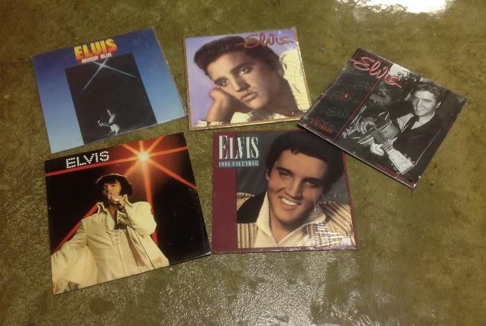A grouping of Elvis albumns and calendars.