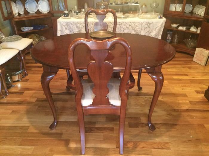Oval dining table with six chairs and two leaves (leaves removed in this photo)