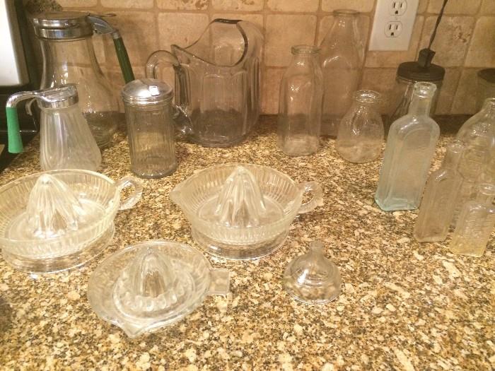 Vintage glass juicers, medicine and milk bottles, syrup pitchers