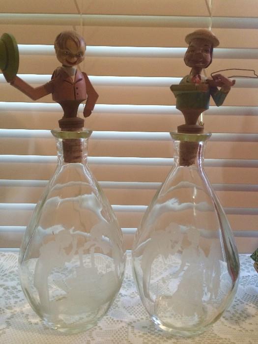 I.W. Harper etched bottles with vintage Anri carved-wood puppet stoppers (one tips his hat, one plays his violin)