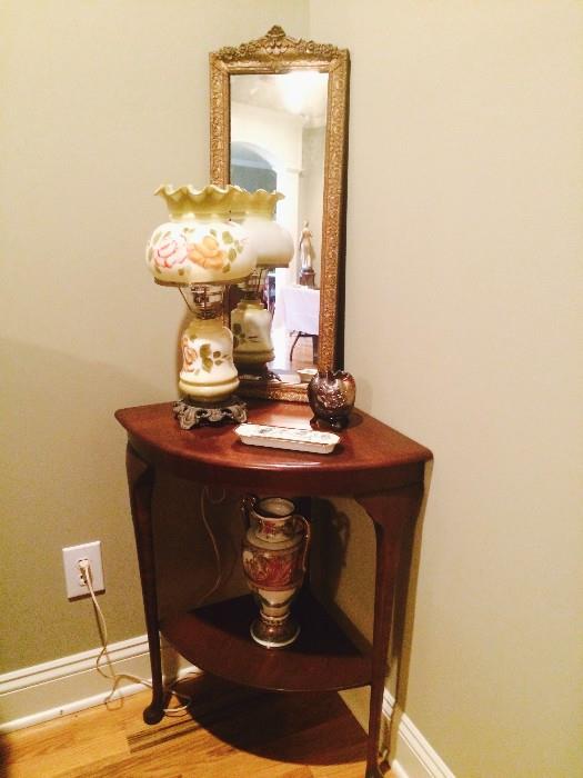 Antique corner table with gilded mirror and another antique lamp