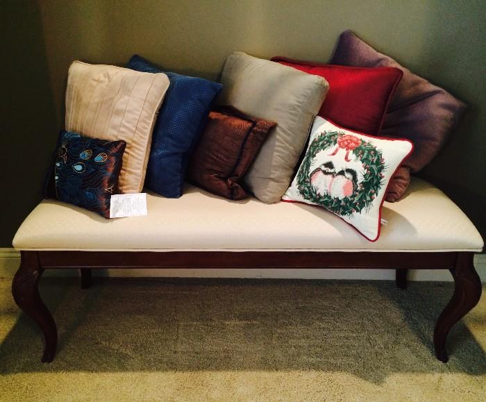 Upholstered bench and throw pillows