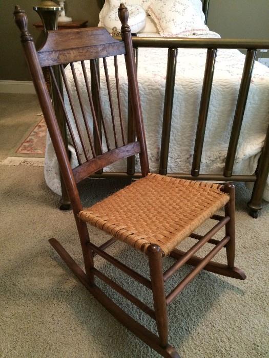 Delicate lady's rocker with woven seat