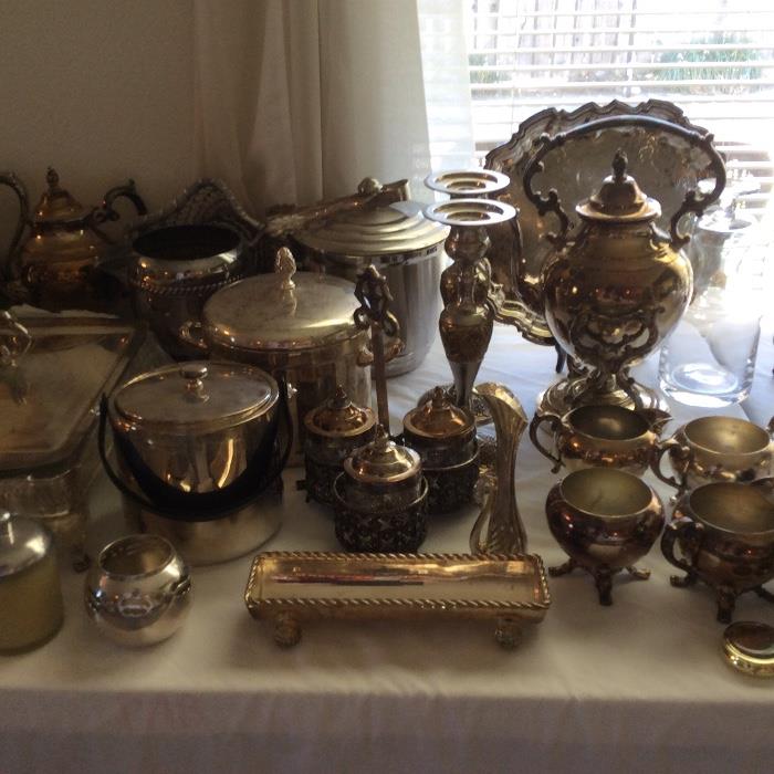 Several tables of vintage silverplate. 