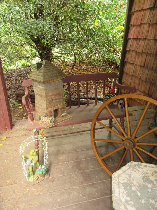 Vintage bench, birdhouse, wagon wheel.