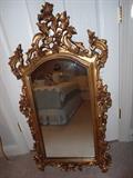 Several mirrors and this one is a very ornate gold mirror.