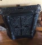 This is an antique enameled French stove.  It opens in front and on the sides.  Can be used as a bar, console and stereo cabinet.  Casts beautiful shadows on the wall and ceiling when candles are put inside.