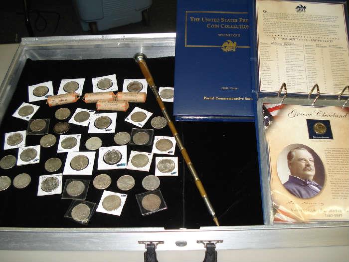 37 US Morgan & Peace dollars. $ rolls, US pre-1964 silver quarters. The "swagger stick" is WWII trench art made out of bullet casings. Possible German.  