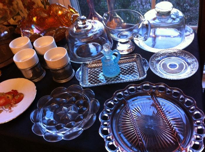 Tables full of glassware, china and decorative wares--vintage blue hobnail cruet, depression glass, cheese dishes and more.