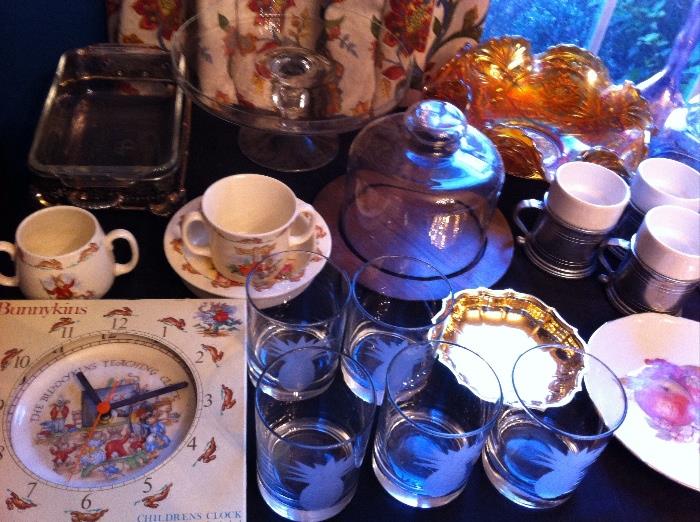 Tables full of glassware, china and décor--Royal Doulton Bunnykins clock, new in box and more.