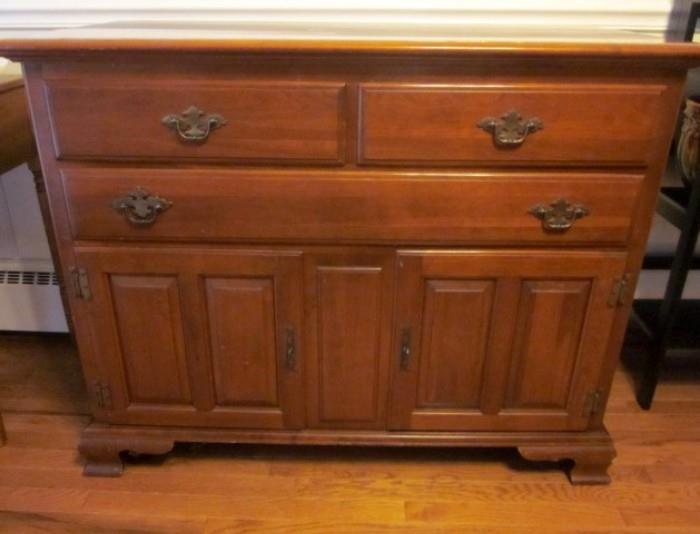 Ethan Allen sideboard, solid cherry wood, three drawers, double doors with shelves and storage area, brass hardware.