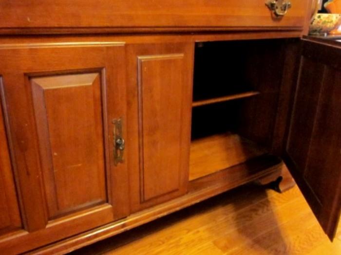 Ethan Allen sideboard, solid cherry wood, three drawers, double doors with shelves and storage area, brass hardware.