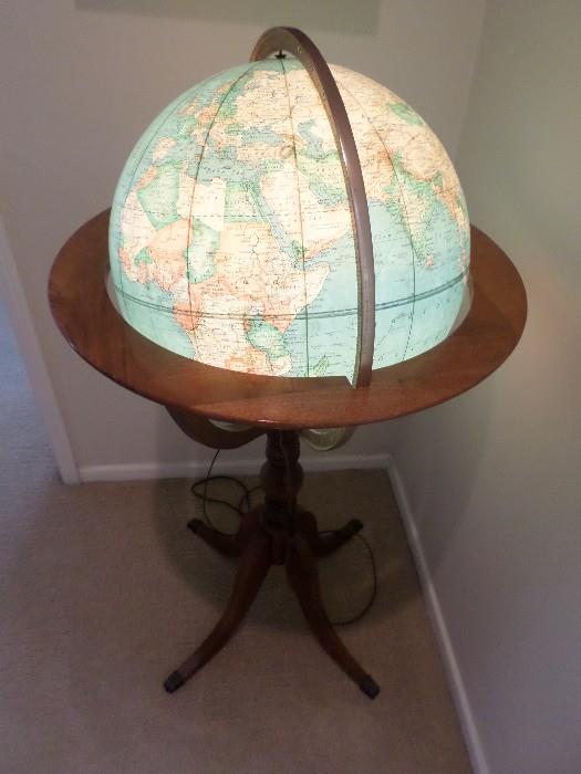 Lit globe on wooden stand by Rand McNally