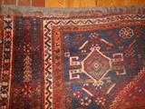 Family Room: A corner of the antique rug which measures 9' x 7' 6" and is "as is."