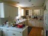 Kitchen: An overview of the kitchen items which include: French Corning; Pyrex; bake-ware; cookware; Tupperware; German white china (AZBERG and HUTSCHENREUTHER) ; china by ROYAL LIMOGES; glassware; cooking utensils; a KRUPS Pro/Aroma coffeemaker; a CUISINART food processor with attachments; and a German scale that measures grams and kilos.
