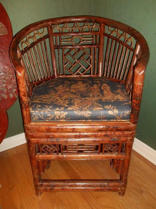 Bedroom #1:  One of the two rattan chairs.  Notice the Asian motif pattern on the custom made chair pad.  It is Chinese men in gold robes on a black background.