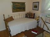 Bedroom #3: A brass daybed/trundle bed (includes both mattresses); small coffee table; prints.
