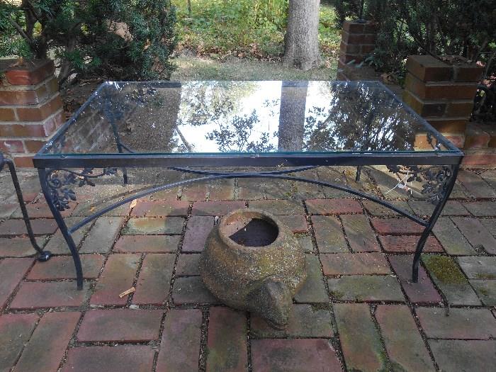 Outside:  A closer view of the glass top table; a ceramic turtle planter.