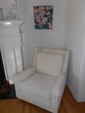Living Room: The matching chair to the sectional (priced separately from the sectional) and one of three prints.