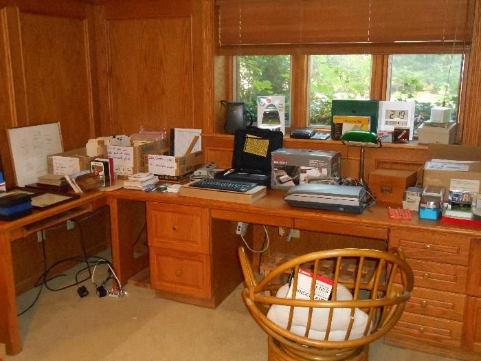 Lower Level:  One side of the large library has a desk which displays office items and some electronics as well as a rattan swivel chair.  Included are:  a RICOH Fax PF-1; a 4-port USB Hub (new in box); an EPSON 4180 photo printer; four small BOSTON speakers; and much more!