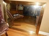 Family Room: A large brass frame mirror reflects the bentwood frame of the Danish Modern "Westnofa" chair.