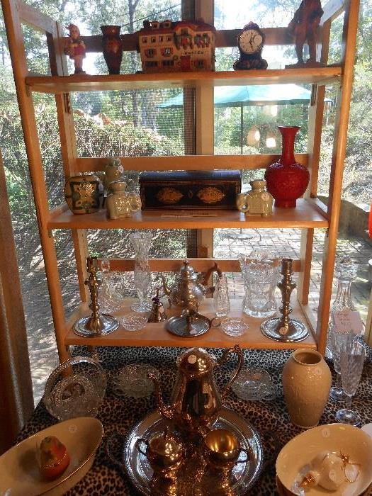 Family Room:  Although difficult to see, displayed are one Hummel #96 figurine; pewter; silver-plate; an antique black lacquer Asian writing/pencil box; a cinnabar vase; and crystal.