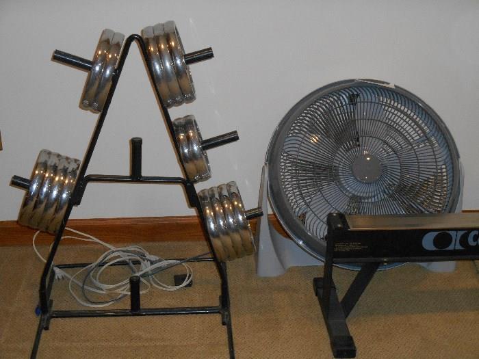 Lower Level-Exercise Room:  Weights are on a stand; to the right is a circular fan.