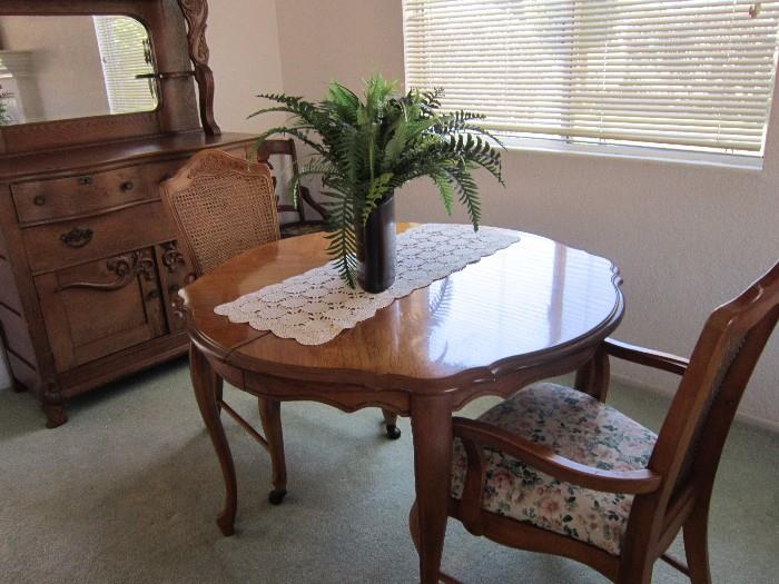 42" cir. Dining table....4 chairs that roll and 2 leaves.  Each leaf is 16" makes a 6ft + table for family events!
