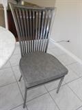 set of four brushes metal chairs with cushioned seats
