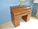 roll top desk, brass student lamp, and brass floor lamp