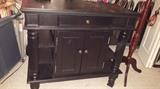 There are two of these, black buffet cabinets.  She was using them in her dressing room with shoes and cosmetics and clothing.  She had amazing style and knew how to decorate!  Could be used for a kitchen island.