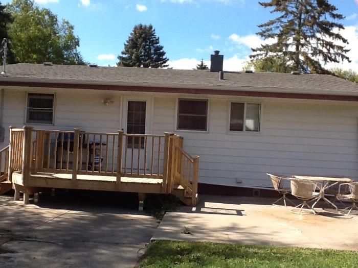 Back of house with new deck. 