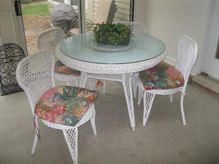 White wicker round table with glass top and four chairs  $175