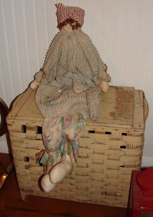 One of man dolls and a vintage wicker clothes basket
