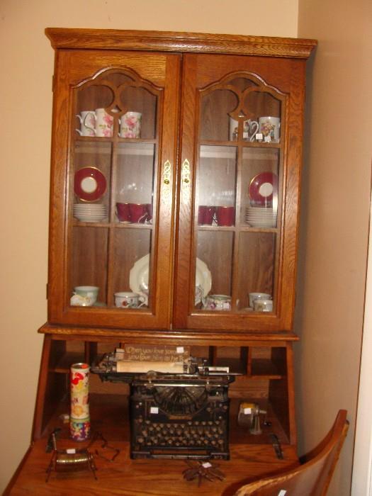 Antique drop front secretary with double glass door cabinets, and drawers below