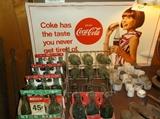Coca-Cola sign and cartons of bottles