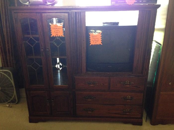 Solid Oak Entertainment Center.  Retractable doors to hide TV, lots of storage and it's in great condition!