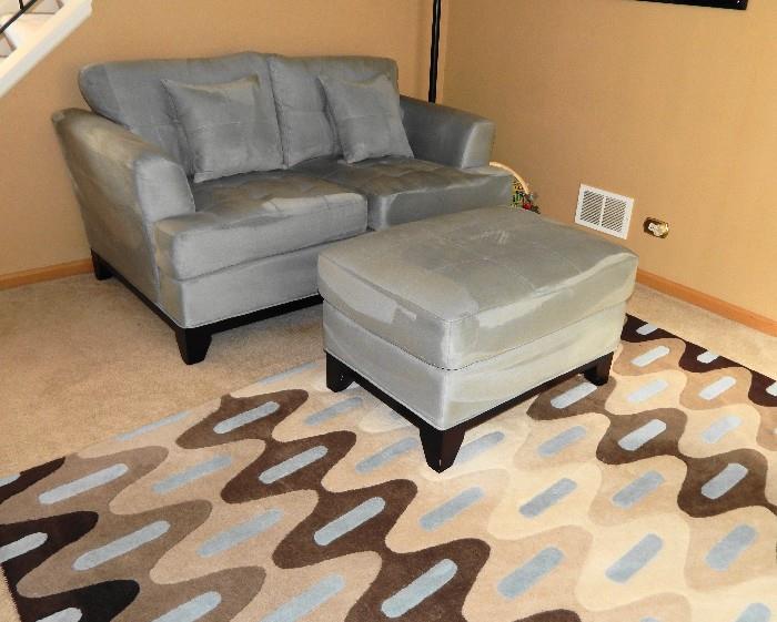 Ice blue loveseat with ottoman and rug