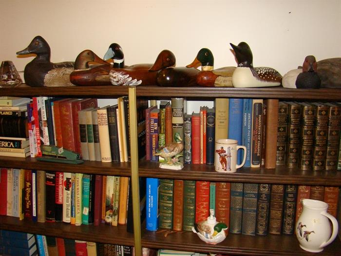 Lots of books and decorative duck decoys.