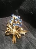 Gold tone nosegay brooch with blue sets