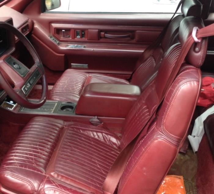 Interior leather seats in front and back are intact and all original.