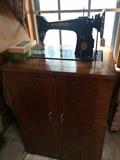 Vintage Singer sewing machine in cabinet